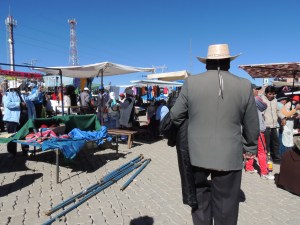 A Bolivian man walks through the El Alto markets.