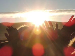 Bolivians welcome the Winter Solstice in Tiwanaku, stretching their open hands towards the New Year's first rays of sun.
