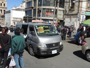 A Trufi toots its way through the streets of downtown La Paz.